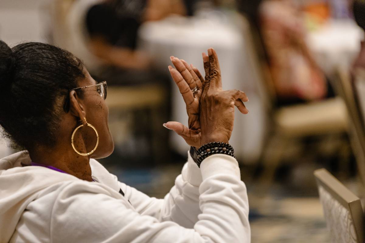 Woman signing during worship.